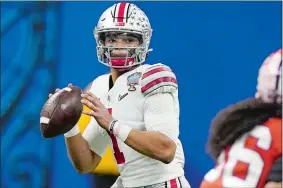  ?? JOHN BAZEMORE/AP PHOTO ?? In this Jan. 1 file photo, Ohio State quarterbac­k Justin Fields looks for a receiver during the Sugar Bowl against Clemson in New Orleans.