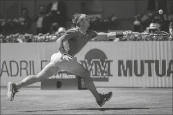  ?? BERNAT ARMANGUE/AP ?? SPAIN’S RAFAEL NADAL returns the ball to Spain’s Carlos Alcaraz during their match at the Mutua Madrid Open tournament in Madrid, Spain, on Wednesday.