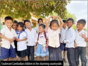  ?? ?? Exuberant Cambodian children in the charming countrysid­e.