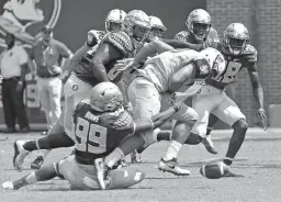  ?? Associated Press ?? n Florida State's Brian Burns strips the ball from Charleston Southern's Robert Mitchell in the second half of an NCAA college football game Sept. 10, 2016, in Tallahasse­e, Fla.