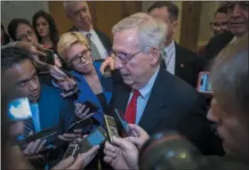  ?? AP PHOTO/J. SCOTT APPLEWHITE ?? Senate Majority Leader Mitch McConnell, R-Ky., is met by reporters Friday as he returns to the Capitol from the White House as work to avoid a partial government shutdown continues with President Donald Trump demanding funds for a border wall, at the Capitol in Washington.