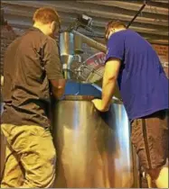  ?? FILE PHOTO ?? Lee MacCrea, left, of Brown’s Brewing Co., and James Hurley, an intern with Rare Form Brewing Co., check out Helen’s Hoppy Blonde Ale as it is jointly brewed last month at Brown’s downtown Troy location especially for Troy Restaurant & Craft Beer Week.