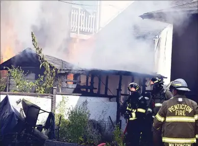  ?? DAVID CROMPTON/Penticton Herald ?? Firemen battle a blaze on Tuesday morning that damaged an Ellis Street home, along with a large shed and travel trailer.