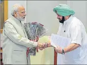  ?? PTI ?? Punjab chief minister Captain Amarinder Singh greeting Prime Minister Narendra Modi in New Delhi on Thursday.