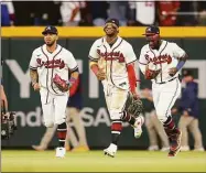  ?? Brett Davis / Associated Press ?? From left, Atlanta Braves outfielder­s Eddie Rosario, Ronald Acuna Jr. and Michael Harris II celebrate after a victory against the Mets.