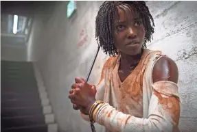  ?? CLAUDETTE BARIUS ?? Lupita Nyong’o stars as a mom whose family faces off with their evil doppelgang­ers in Jordan Peele’s horror film “Us.”