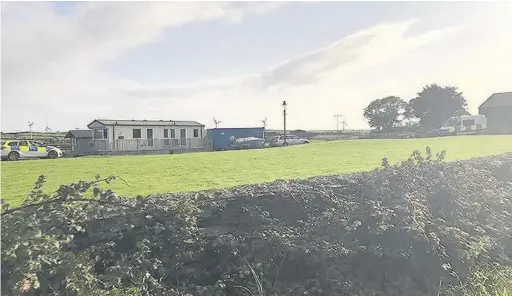  ??  ?? Police and Maritime and Coastguard Agency search house in Cemaes