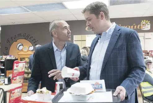  ?? JACQUES BOISSINOT / THE CANADIAN PRESS ?? Conservati­ve Leader Andrew Scheer, right, and Saguenay-Le Fjord candidate Richard Martel campaign last week in Saguenay, Que. Martel won the riding in a byelection on Monday.