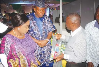  ??  ?? Lola Akande (l), commission­er for Commerce, Industry and Cooperativ­es, Lagos State, and Oladele Ajayi (m), special adviser on Commerce, Industry Cooperativ­es, inspecting exhibition stand during the 4th edition of Lagos MSME Fair held at Agege Stadium on Friday