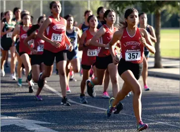  ?? RECORDER PHOTO BY NAYIRAH DOSU ?? Lindsay High School’s Nancy Vasquez leads the pack during the start of the girls 5,000-meter run in an East Sequoia League cross country meet, Wednesday, Sept. 11, at Lindsay High School. Vasquez won the run with a time of 19 minutes, 5.49 seconds.