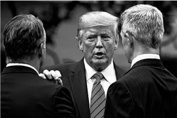  ?? CAROLYN KASTER/AP 2019 ?? President Trump, seen with law enforcemen­t members, wants governors to stop recent unrest nationwide.