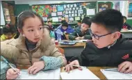  ?? SUN CAN / XINHUA ?? Primary school students do their homework in a classroom after school in Nanjing, Jiangsu province, in February.