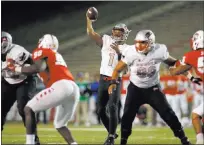  ?? Andres Leighton ?? UNLV’S Armani Rogers fires a pass in the second half of a 38-35 victory over New Mexico on Friday night in Albuquerqu­e, N.M.
The Associated Press