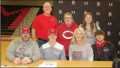  ?? ?? McDonald County Senior Cross Dowd, seated between his parents, Craig and Brandi Dowd, and accompanie­d by members of his family, signed his letter of intent to play baseball at Coffeyvill­e Community College.