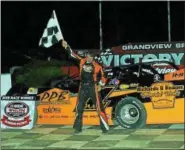  ?? RICK KEPNER - FOR DIGITAL FIRST MEDIA ?? Chuck Schutz raises the checkered flag after gaining his first Late Model win of the 2018 season Saturday night at Grandview Speedway.