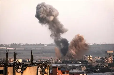  ?? AFP via Getty Images ?? Smoke billows above buildings in Rafah in the southern Gaza Strip during Israeli bombardmen­t on Saturday.