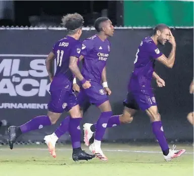  ?? STEPHEN M. DOWELL/ORLANDO SENTINEL ?? Orlando City players celebrate after Tesho Akindele, right, scored against New York City FC during the MLS is Back Tournament Tuesday night at ESPN Wide World of Sports.