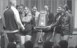  ?? Photo by Becky Polaski ?? Senior members of the Lady Crusader volleyball team present ECC Principal John Schneider with the PIAA 1A girls’ volleyball championsh­ip trophy on Saturday evening during a special ceremony held in the ECCHS auditorium.