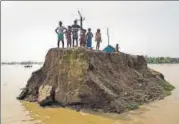  ?? AP PHOTO ?? Villagers wait for help on a broken road in Morigaon district, Assam, on Tuesday.