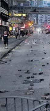  ??  ?? Hong Kong streets where the police and protesters clashed were left littered with bricks.