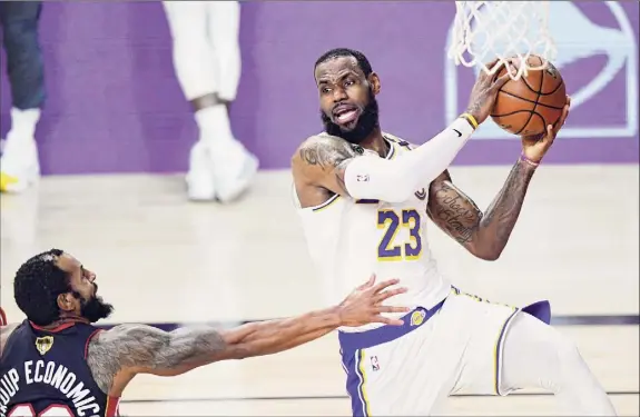 ?? Douglas P. Defelice / Getty Images ?? The Lakers’ Lebron James had 28 points, 14 rebounds and 10 assists to help put away the Heat in Game 6 of the NBA Finals on Sunday night.