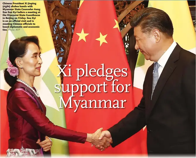  ?? Photo: AFP ?? Chinese President Xi Jinping (right) shakes hands with Myanmar State Counselor Aung San Suu Kyi before a meeting at the Diaoyutai State Guesthouse in Beijing on Friday. Suu Kyi is on an official visit and is meeting Chinese officials to boost...