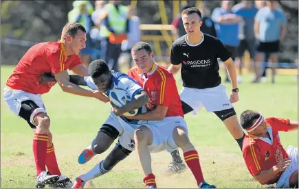  ?? Picture: FREDLIN ADRIAAN ?? BIG ONSLAUGHT: Westering High’s Azukiwe Sigcu is tackled by Otto du Plessis players during their schools match at Westering at the weekend