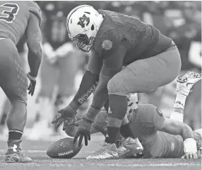  ?? GETTY IMAGES ?? Auburn defensive tackle Montravius Adams recovers a fumble in January during the second half of the Senior Bowl, where he boosted his draft stock with a strong performanc­e.