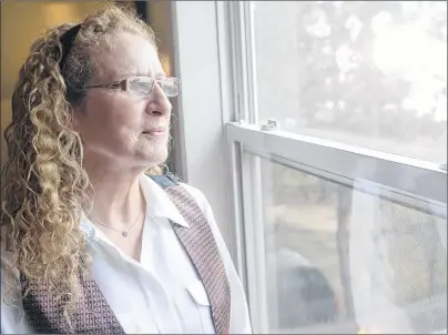  ?? MITCH MACDONALD/THE GUARDIAN ?? Cheryl Myers looks out her window of her Borden-Carleton home where she lives with her grandson. Myers has been caring for her grandson since 2013 and was relieved to hear about a new grandparen­ts and care providers program she thought would be...