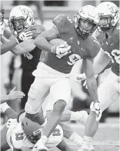  ?? STEPHEN M. DOWELL/TNS ?? UCF kick returner Mike Hughes runs a kickoff back 91 yards for a first-quarter touchdown against Austin Peay at Spectrum Stadium in Orlando on Saturday.