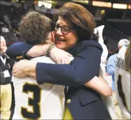  ?? Lori Van Buren / Albany Times Union ?? Quinnipiac coach Tricia Fabbri, right, pictured hugging Adily Martucci after winning last year’s MAAC championsh­ip game, has constructe­d a sustainabl­y successful program.