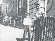  ?? CONTRIBUTE­D ?? While his mother, Mary Christoff can be seen seated in the background, John Christoff stands with his older brother Jimmy Christoff, right, in Glace Bay. Mary Christoff and her son Jimmy would die two years to the day of each other, with Mary passing away on May 3, 1951 and Jimmy on May 3, 1953.