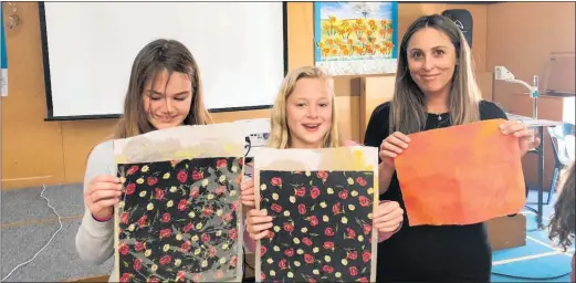  ??  ?? PAENGAROA School pupils, from left: Brylee Brackenrid­ge and Jasmine Buchanan with Comvita’s Paula Firmin with their beeswax wraps.