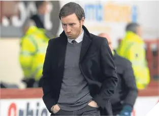  ??  ?? Ian Cathro looks glum at full-time after defeat in Glasgow.