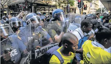  ??  ?? STUDENT PROTEST: Police in riot gear scuffle with protesting students in the streets of central Cape Town on the day of the state of the nation address