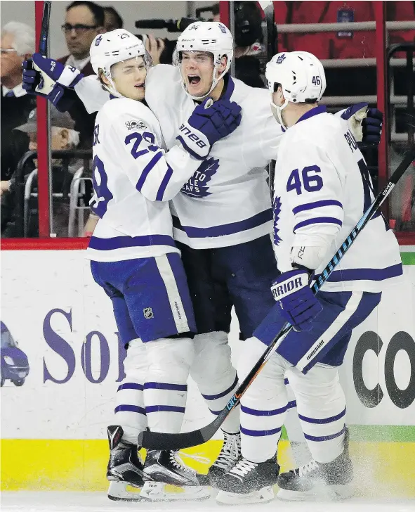  ?? — THE ASSOCIATED PRESS ?? Toronto Maple Leafs forward Auston Matthews, centre, is congratula­ted by teammates William Nylander and Roman Polak after scoring a highlight-reel goal Sunday against the Carolina Hurricanes during their 4-0 victory at PNC Arena in Raleigh, N.C.