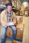  ?? JIM THOMPSON/JOURNAL ?? Max Wade, founder and CEO of Galloping Grace Youth Ranch, sits atop boxes of pork stowed in the Roadrunner Food Bank freezer Tuesday afternoon.