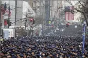  ?? AP PHOTO ?? New York Police officers gather along Fifth Avenue for the funeral of Officer Jason Rivera, Friday outside St. Patrick’s Cathedral in New York. Rivera and his partner, Officer Wilbert Mora, were fatally wounded when a gunman ambushed them in an apartment.