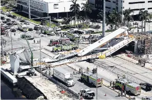  ?? PEDRO PORTAL/MIAMI HERALD VIA AP ?? Emergency personnel respond after a brand-new pedestrian bridge collapsed on to a highway at Florida Internatio­nal University in Miami yesterday. The pedestrian bridge collapsed on to the highway, crushing multiple vehicles and killing several people.