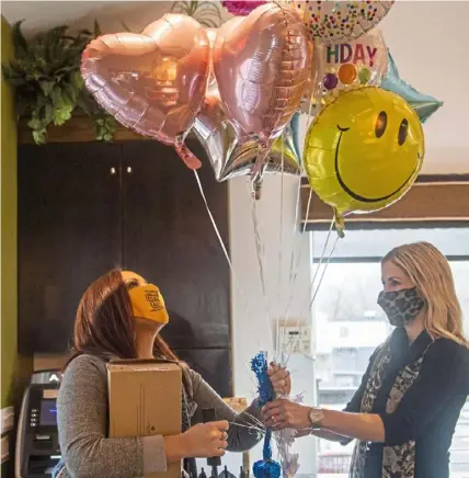  ?? Emily Matthews/Post-Gazette ?? Nicole Cox, left, of Aliquippa, a two-time breast cancer survivor, celebrates her birthday with Stephanie Scoletti, a leukemia survivor who started Young Adult Survivors United. The group hosted a photo shoot last month for members.