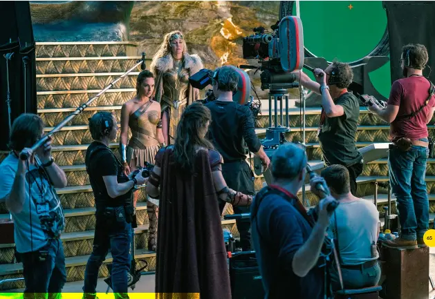  ??  ?? AMAZON HQ (above) Gal Gadot’s Diana Prince and Connie Nielsen’s Queen Hippolyta on set in Themyscira’s throne room; Lucy Davis (bottom-left) plays fast-quipping Etta Candy.