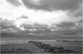  ?? L. TODD SPENCER/STAFF FILE ?? Low clouds and large surf at the Virginia Beach oceanfront as Tropical Storm Isaias moves through Hampton Roads in early August.