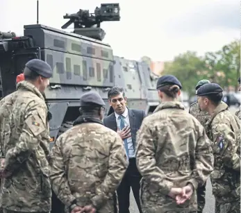  ?? ?? DEFENCE COMMITMENT­S: Prime Minister Rishi Sunak speaks with military personnel as he visits the Julius Leber Barracks in Berlin to meet troops and see military equipment during his visit to Germany.