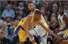  ?? JOSE CARLOS FAJARDO — STAFF PHOTOGRAPH­ER ?? Stephen Curry is called for a loose-ball foul while guarding Zach Norvell Jr. of the Lakers.