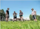  ??  ?? Tararua farmers, from left, Blair Castles, Mark Diamond and Brad Mcnaughton talk with Dairy NZ’S Adam Duker about planting plantain to reduce nitrogen.