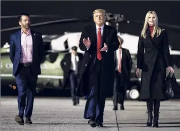  ?? Erin Schaff / New York Times ?? President Donald Trump, accompanie­d by his children, Donald Trump Jr. and Ivanka Trump, on Monday, walks toward Air Force One at Dobbins Air Force Base in Georgia. The bid to remove Trump from office and strip him of his power without waiting until his term expires on Jan. 20 capped a traumatic week.