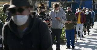  ?? JAE C. HONG — THE ASSOCIATED PRESS ?? People wait in line for a COVID-19 test in Los Angeles earlier this month.