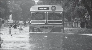  ??  ?? A stranded bus. The city’s homeless people were unable to cook on the ground due to the high flood waters. Photograph: Shailesh Andrade/Reuters