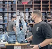  ?? TSAFRIR ABAYOV/AP ?? Consumers shop at a clothing store Sunday in Beersheba, Israel. The country has lifted many of its virus restrictio­ns and started to reopen its economy.