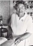  ?? Courtesy of Susan Turnley and family of Gladys Taber ?? Gladys Taber, cooking in her kitchen at Stillmeado­w Farm in Southbury, is seen in a photo which hangs in the office of Susan J. Turnley.